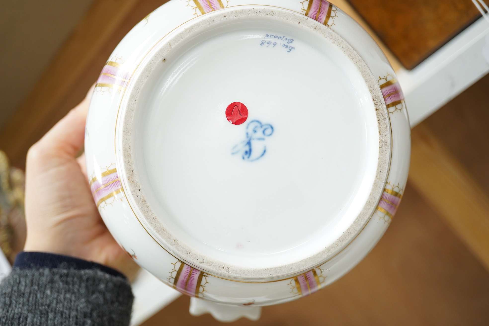 A pair of Dresden wine coolers with floral decoration, 15cm high, 18cm diameter. Condition poor to fair, cracks to the base of one.